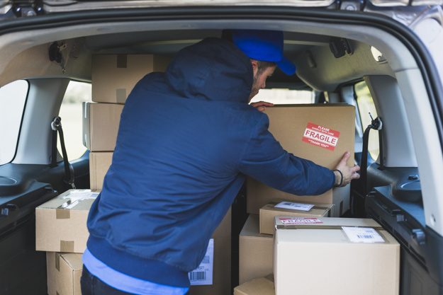 deliveryman-car-with-carton-boxes_23-2147767539-aed5010e
