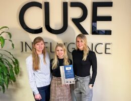 Members of the CURE Intelligence Marketing team receive the Social Media Quality Certificate